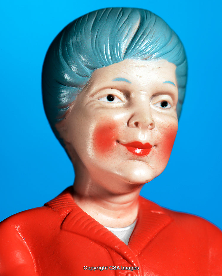 Close-Up of Vintage Plastic Figurine Portrait on Blue Background