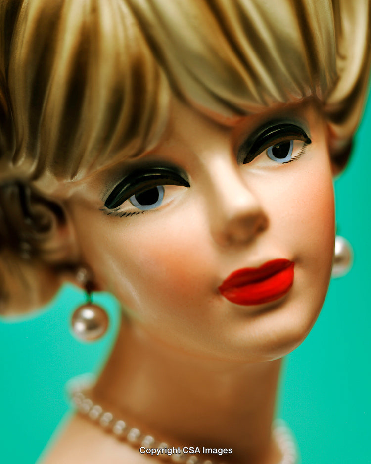 Close-Up of a Vintage Ceramic Figurine with Red Lips and Pearl Accessories