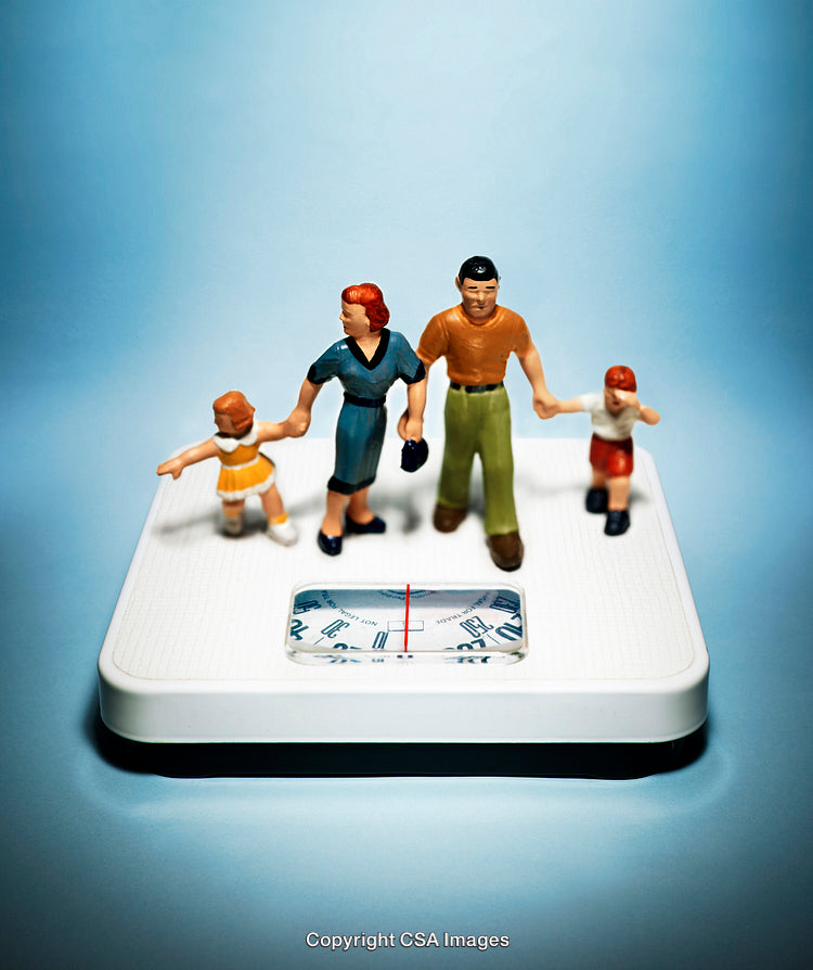 Miniature Family Figures Standing on a White Scale Against a Blue Background