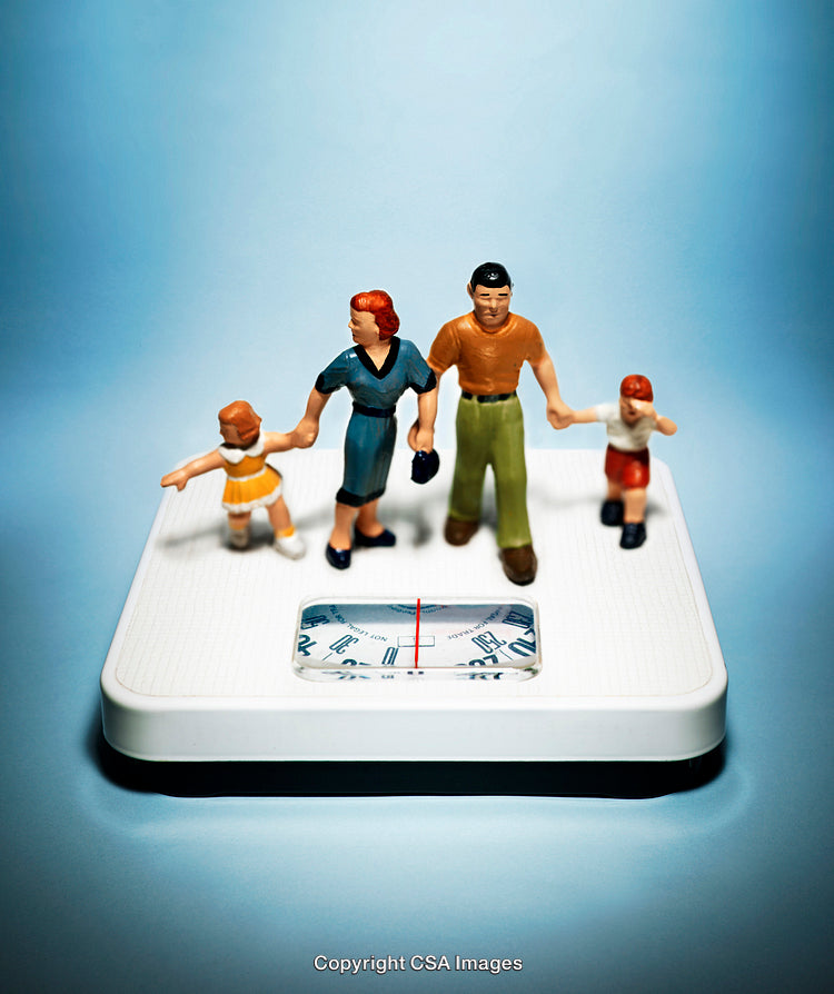 Miniature Family Figures Standing on a White Scale Against a Blue Background