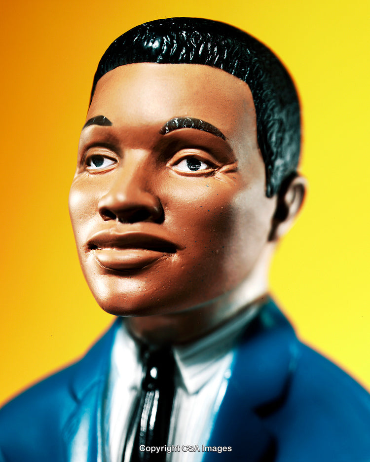 Close-Up of Stylish Plastic Figurine With Yellow Background