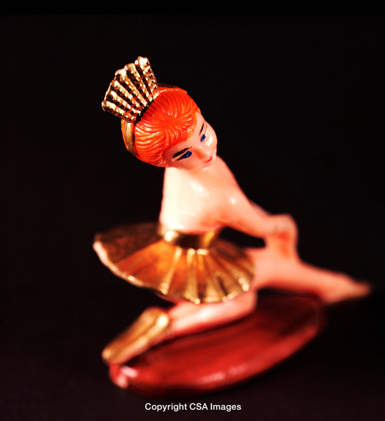 Vintage Plastic Ballerina Figurine With Golden Details and Crown on Black Background