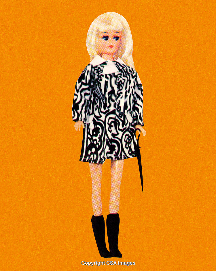 Retro Fashion Doll With Blonde Hair Against Bright Yellow Background