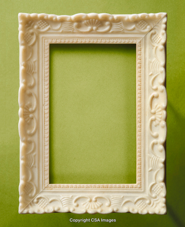 Intricately Designed Ivory Frame on Light Green Background with Decorative Details