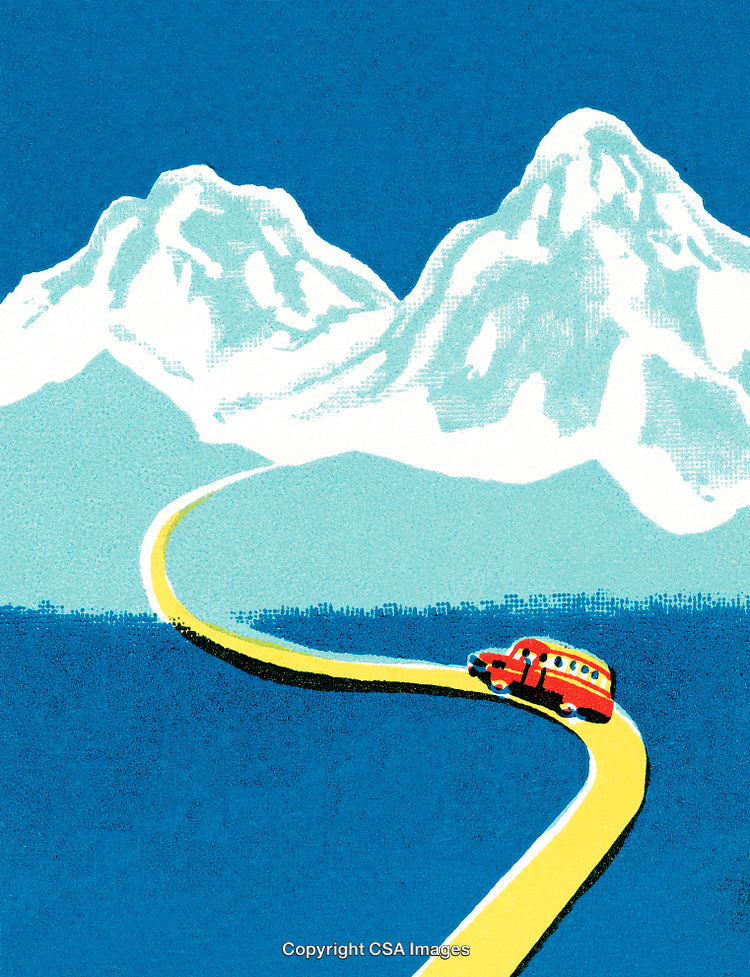Bus Traveling Along a Winding Road With Snowy Mountains and Blue Sky