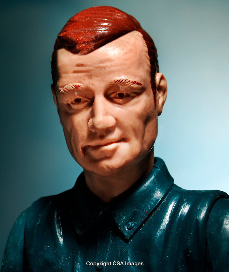 Close-Up of Male Toy Figure with Blue Shirt and Red Hair
