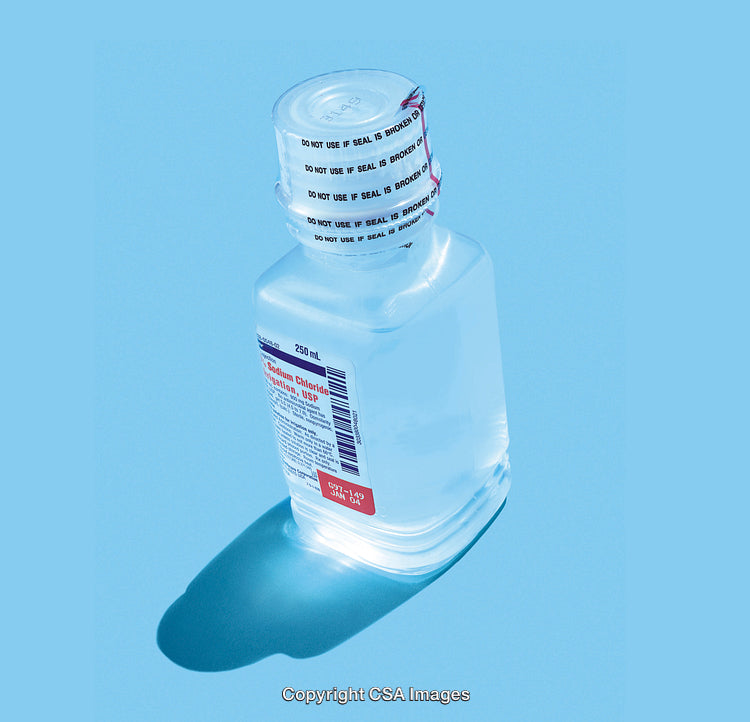 Bottle of Sodium Chloride Solution Against Blue Background