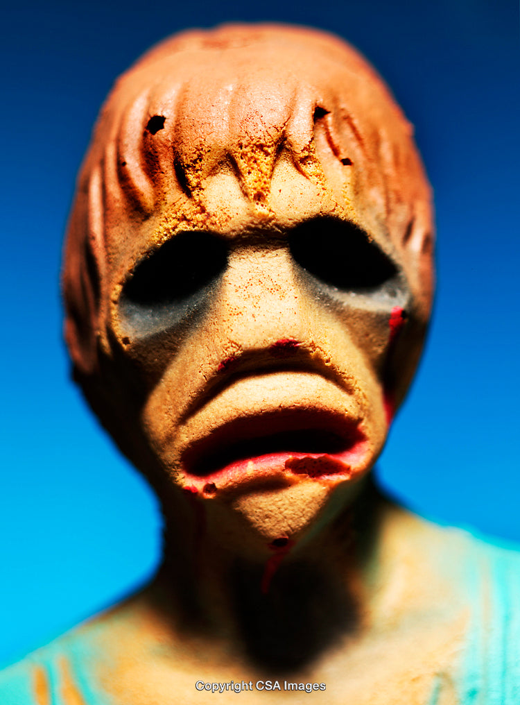 Close-Up of a Dramatic Painted Figurine Against a Blue Background