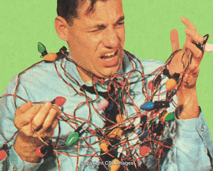 Man Tangled in Colorful Holiday Lights on Green Background