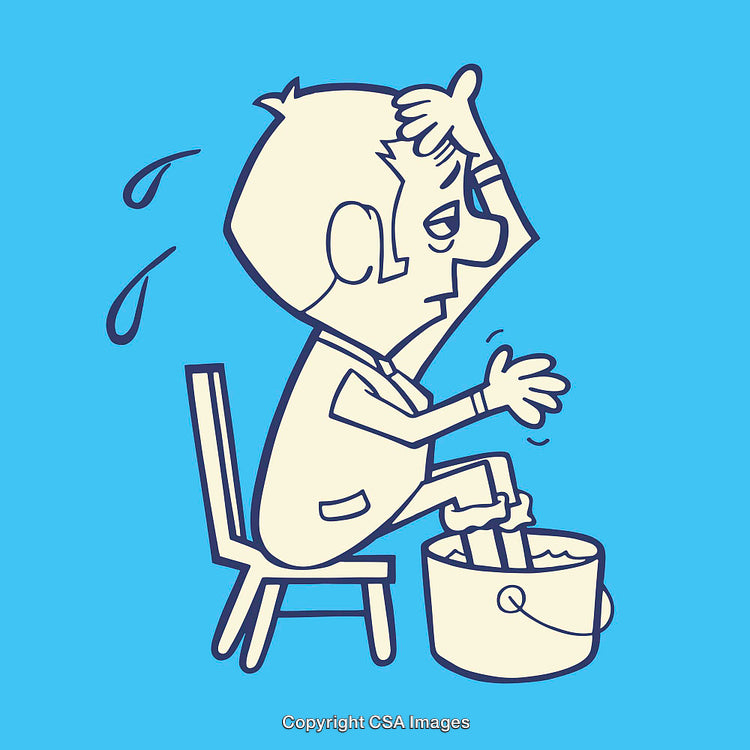 Man Cooling Off by Soaking Feet in a Bucket of Water