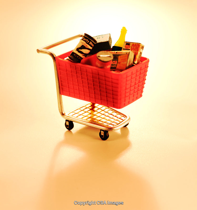 Miniature Shopping Cart Filled with Toy Groceries on Orange Background