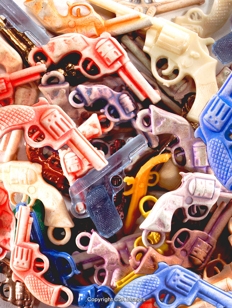 Close-Up of Colorful Plastic Toy Guns in Various Arrangements