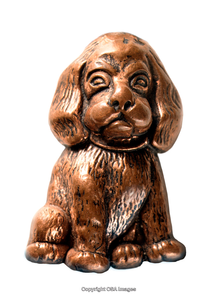 Bronze Painted Dog Figurine Isolated Against a White Background