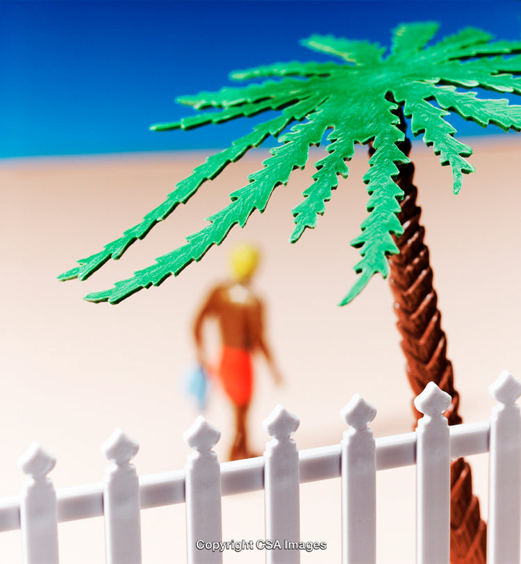 Miniature Scene of Palm Tree and Figure Beyond Fence in Sunlight