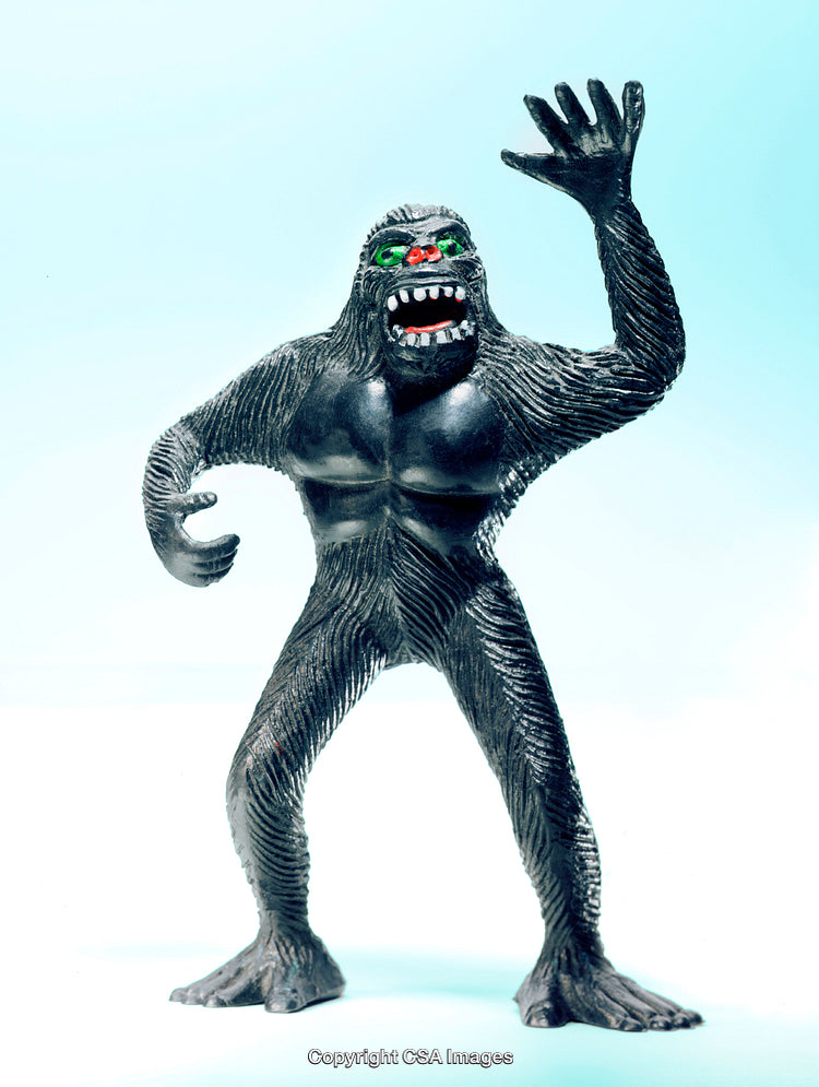 Dark Toy Figure Resembling Bigfoot With Illuminated Background