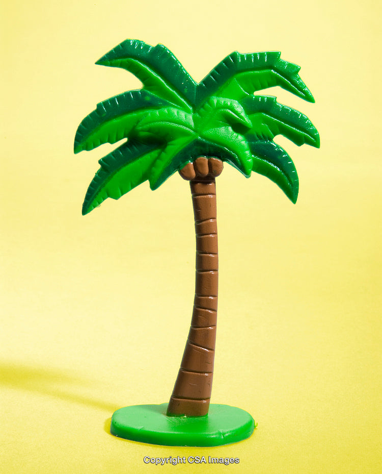 Bright Green Plastic Palm Tree on Yellow Background