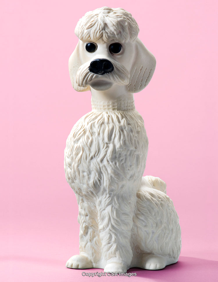 White Poodle Figurine on a Pastel Pink Background