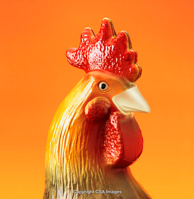 Close-Up View of a Colorful Ceramic Rooster on an Orange Background