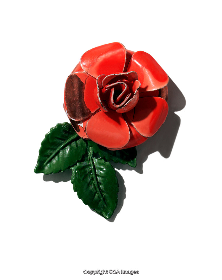 Closeup of A Decorative Plastic Flower with Green Leaves on White
