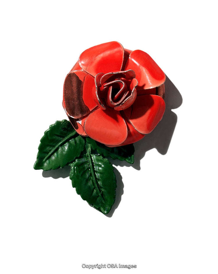 Closeup of A Decorative Plastic Flower with Green Leaves on White