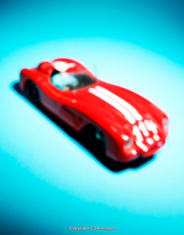 Red Model Car on a Vibrant Blue Background