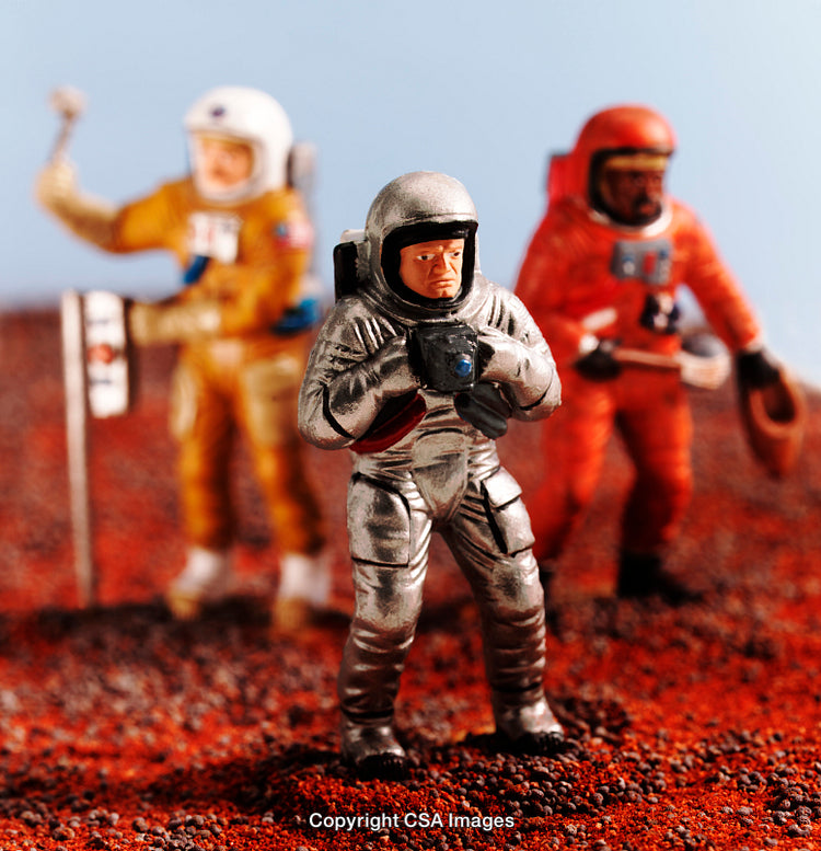 Toy Astronaut Figures Exploring a Simulated Martian Environment