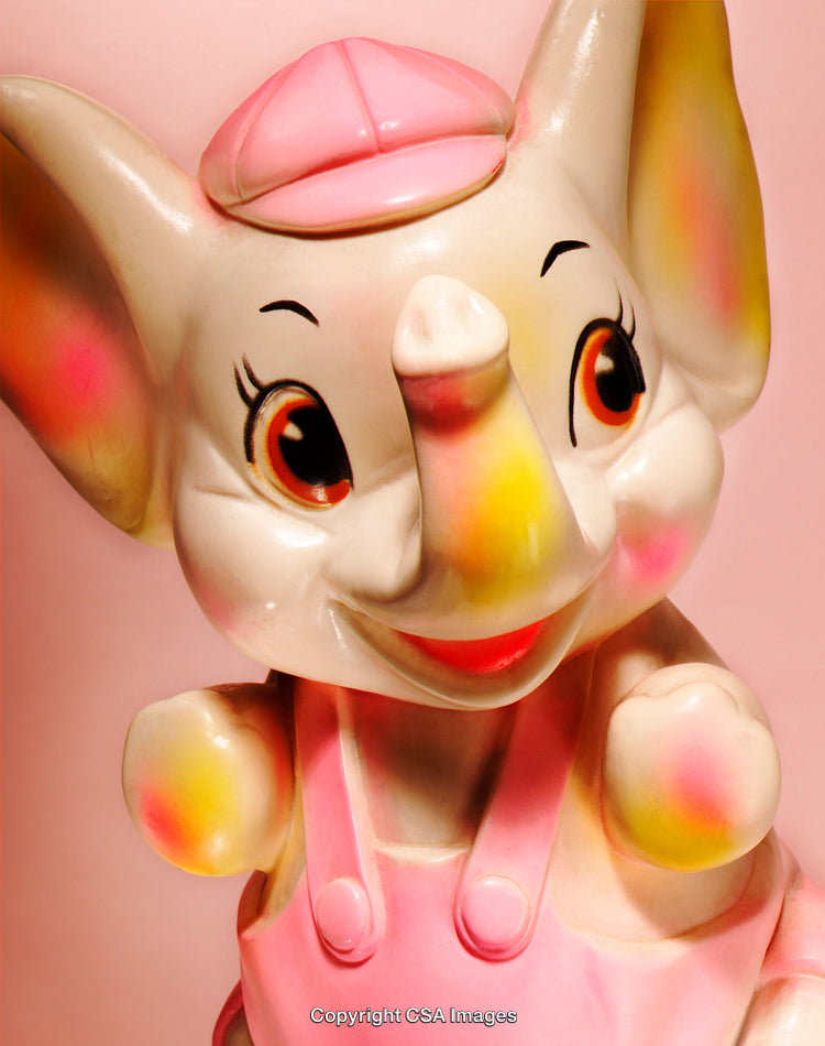 Colorful Elephant Figurine with Pink Hat and Overalls on Pink Background