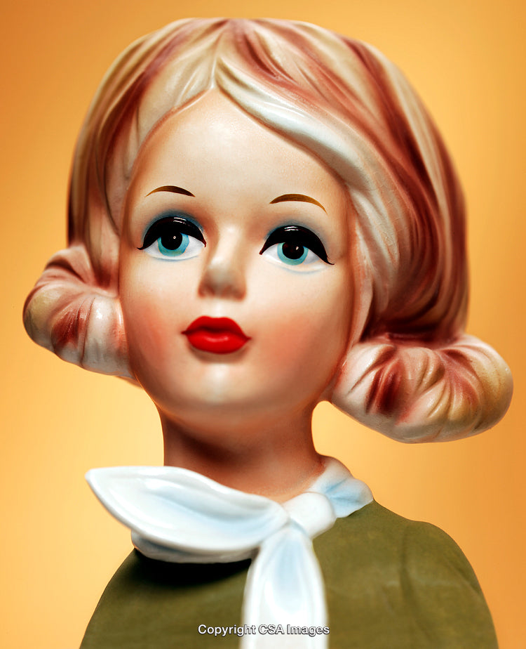 Vintage Ceramic Lady Figurine with Stylish Details on Warm Orange Background