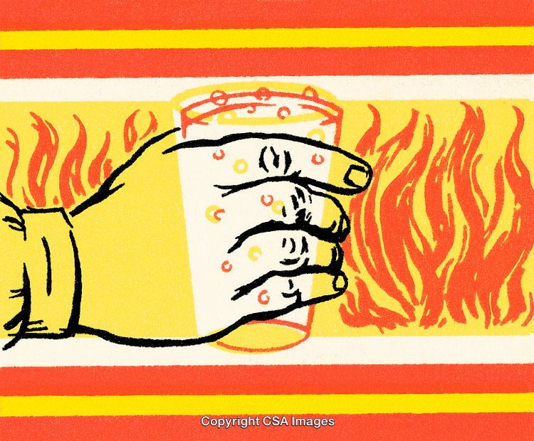 Hand Holding a Beverage Glass Against a Fiery Background in Bold Colors