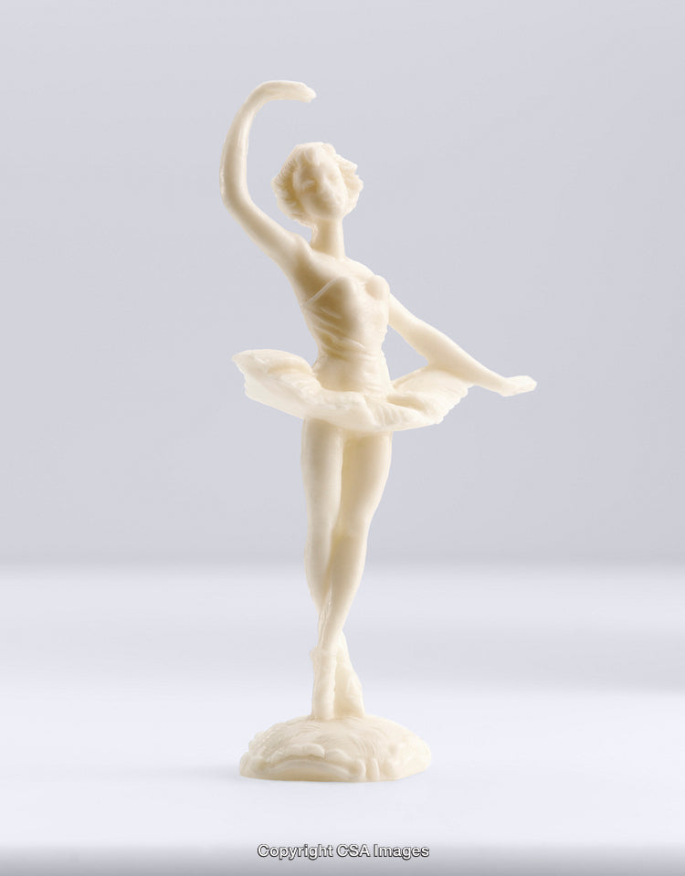 White Plastic Figurine of a Ballerina Doing a Graceful Pose