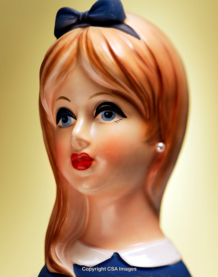 Close-Up of a Classic Figurine with Elegant Styling on Yellow Background