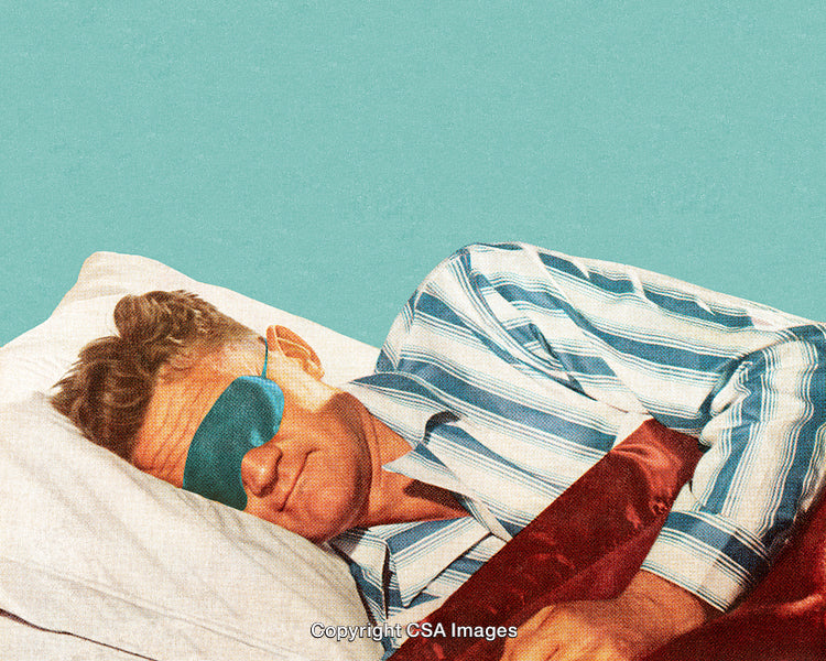 Man Wearing a Sleep Mask Relaxing in Bed with a Calm Expression