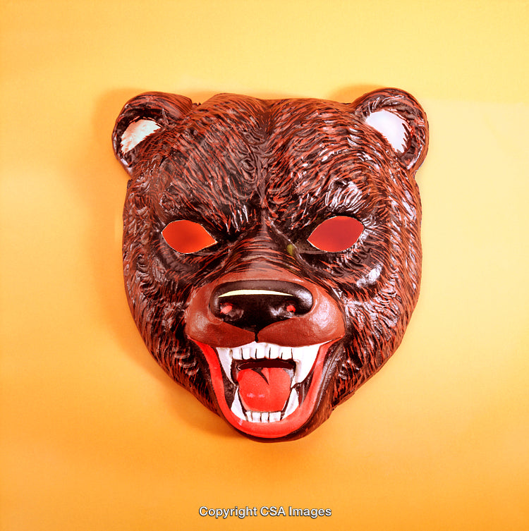 Brown Bear Mask Displayed on Vibrant Yellow Background for Playful Themes