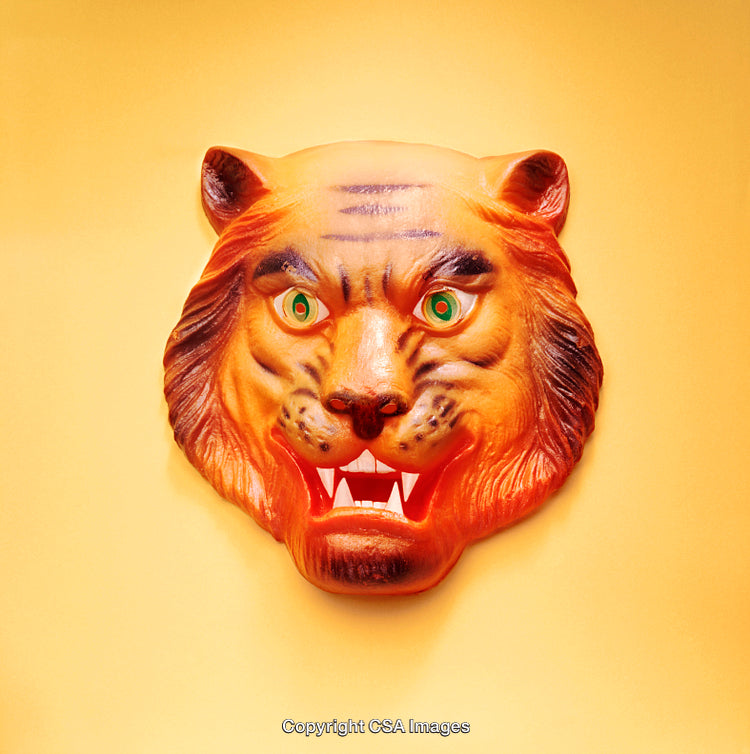 Tiger-Shaped Plastic Mask Against a Bright Yellow Background