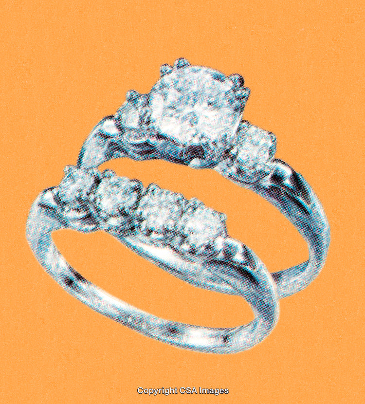 Elegant Diamond Rings Against Vibrant Orange Background for Jewelry Display