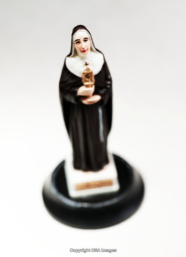 Detailed Close-Up of a Figurine of a Catholic Nun Holding a Monstrance
