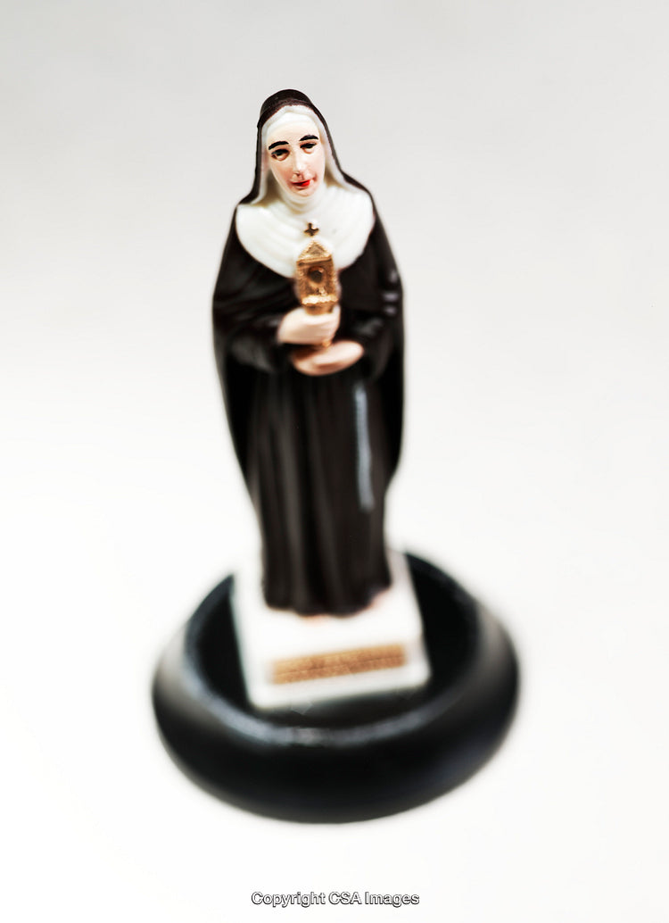 Detailed Close-Up of a Figurine of a Catholic Nun Holding a Monstrance
