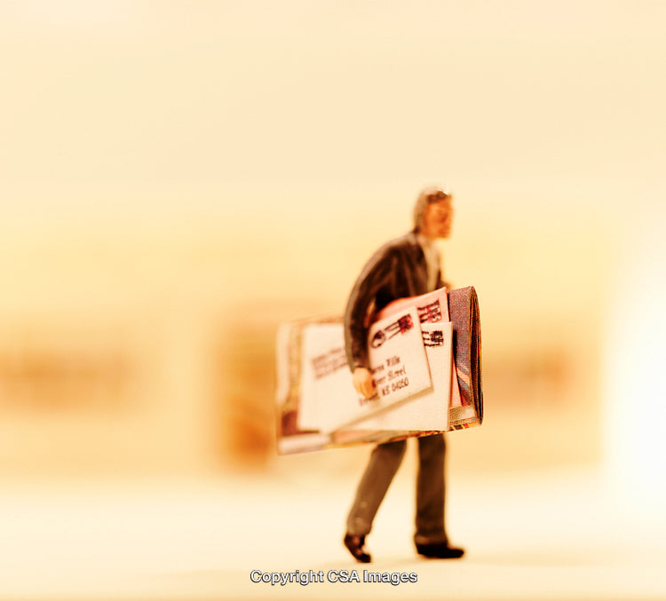 Miniature Figurine Carrying Mail in Warm Lighting Focused on Details