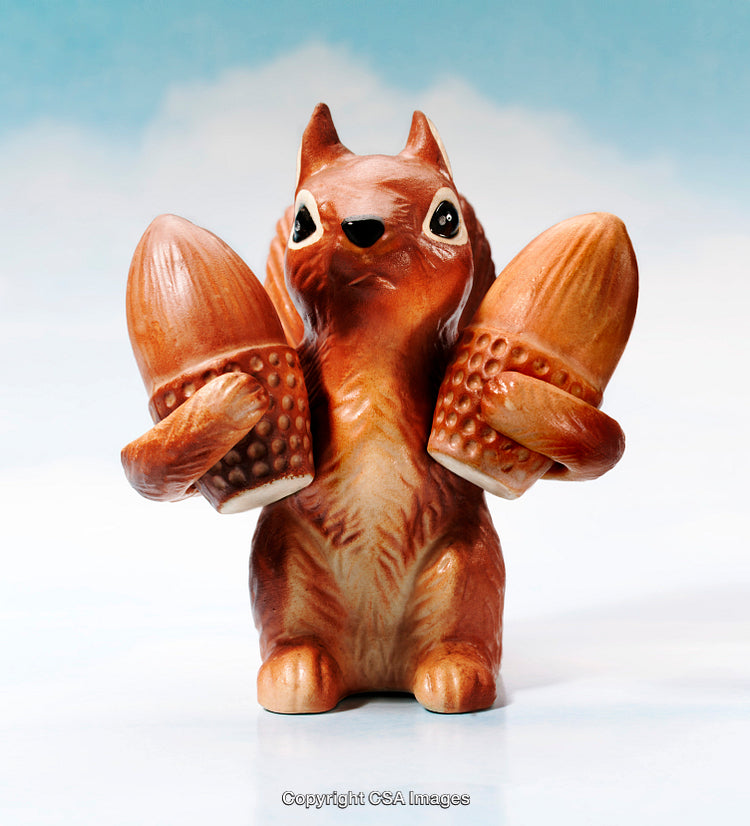 Ceramic Squirrel Figurine Holding Two Large Acorns in a Playful Pose