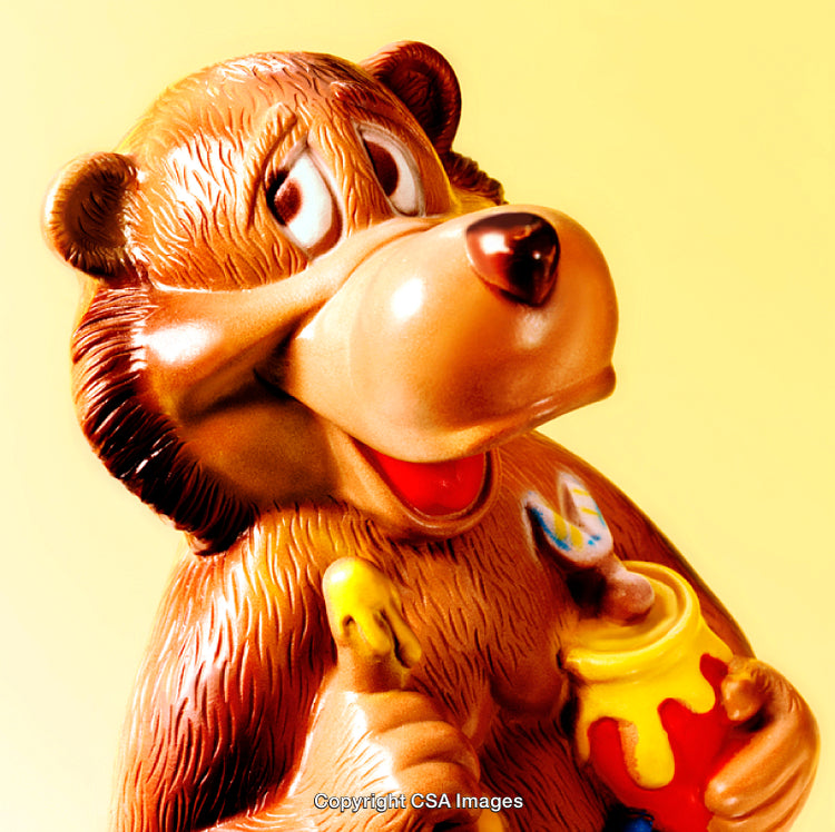Colorful Toy Bear With Honey in a Brightly Lit Setting