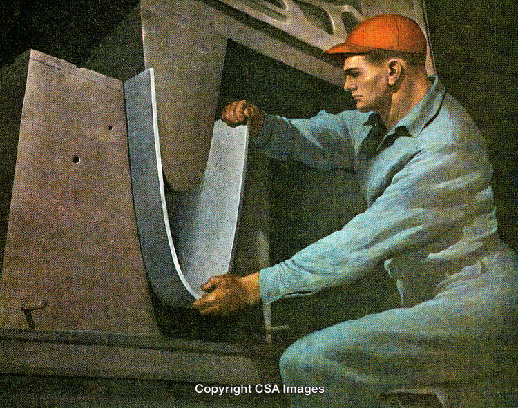 Industrial Worker Performing Metal Bending Process on Manufacturing Machinery