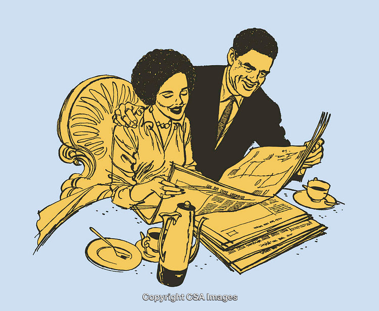 Happy Couple Reading a Newspaper Together Over Morning Coffee