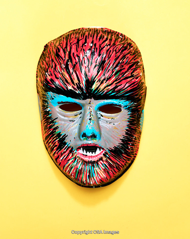 Colorful Folk-Inspired Mask Displayed Against a Bright Yellow Background