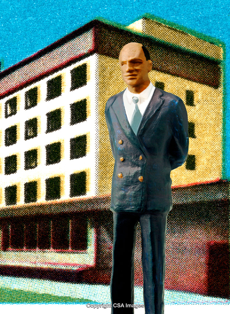 Toy Figurine of a Businessman in Front of a Modern Building