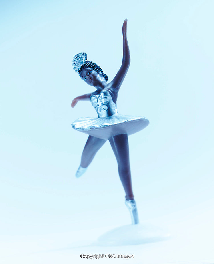 Graceful Ballerina Figurine in Elegant Pose and Soft Blue Background