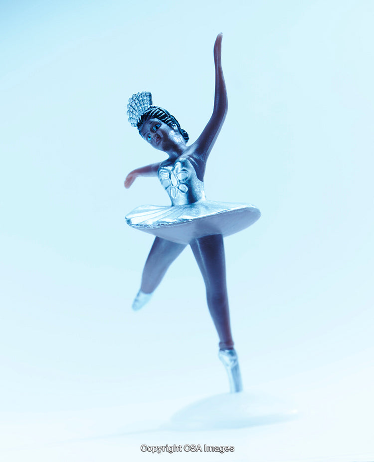 Graceful Ballerina Figurine in Elegant Pose and Soft Blue Background