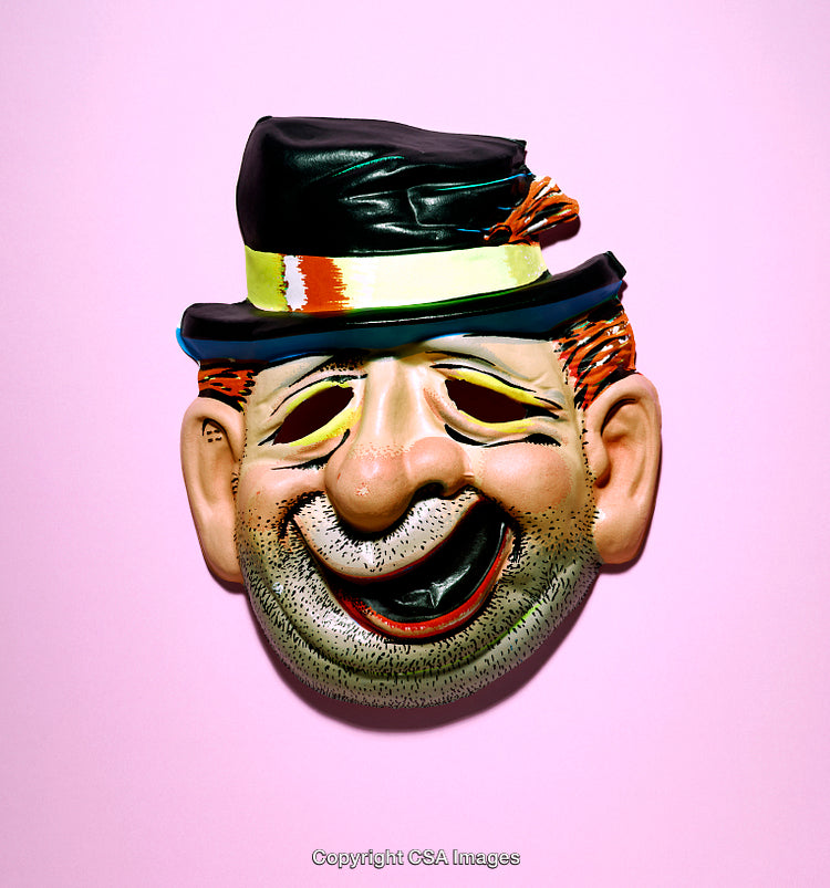 Colorful Vintage Clown Mask Against a Pink Background