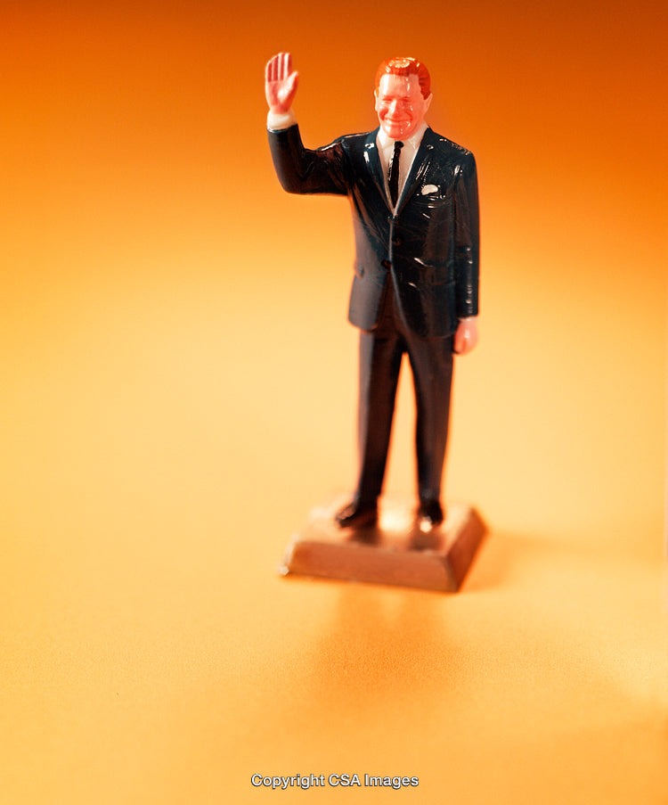 Plastic Figurine Waving on a Bright Orange Background