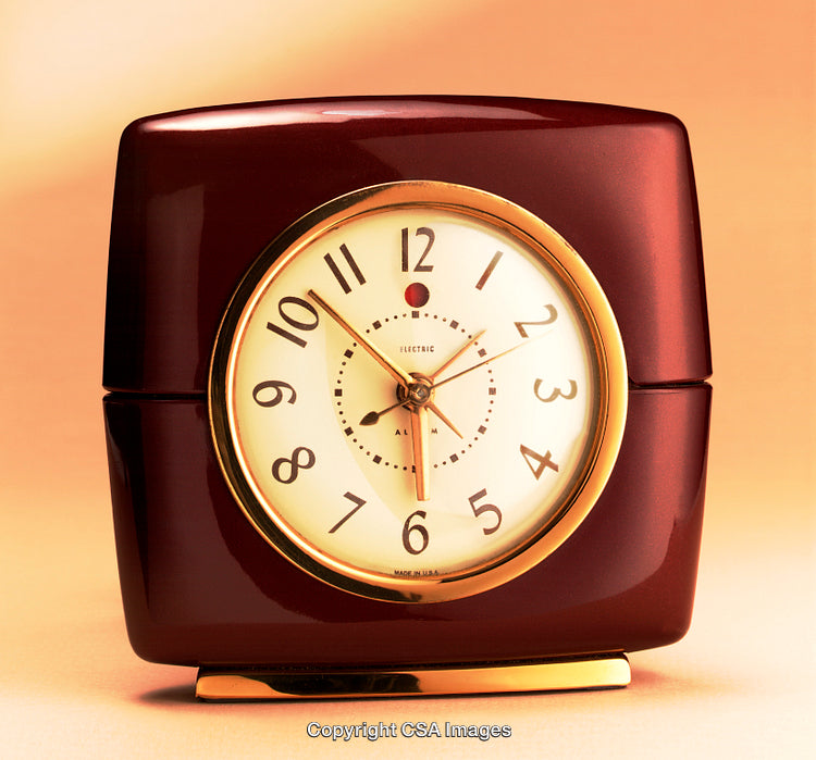 Vintage Red Alarm Clock with Golden Accents on Warm Background