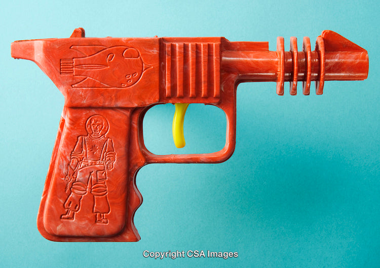 Retro Orange Plastic Toy Ray Gun on a Creative Background
